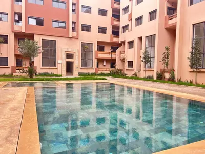 an empty swimming pool in front of a building at Atlas Dream Studio pool & parking included in Marrakech