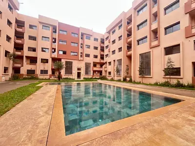 a swimming pool in front of an apartment building at Atlas Dream Studio pool & parking included in Marrakech