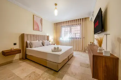 a bedroom with a large bed and a window at Atlas Dream Studio pool & parking included in Marrakech