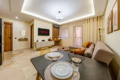 a living room with a table and a couch at Atlas Dream Studio pool & parking included in Marrakech