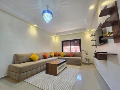 a living room with a couch and a table at Appartement de luxe, Marrakech Menara in Marrakech