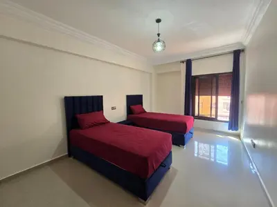 a bedroom with two beds and a window at Appartement de luxe, Marrakech Menara in Marrakech