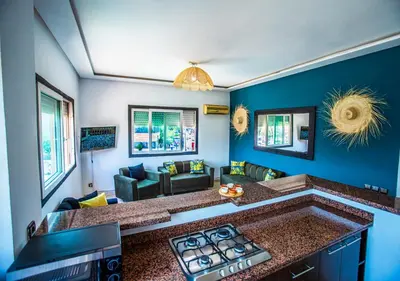 a kitchen with a stove top in a living room at Appartement moderne Guéliz, Centre Marrakech in Marrakech