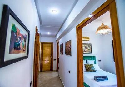 a small bedroom with a bed and a mirror at Appartement moderne Guéliz, Centre Marrakech in Marrakech