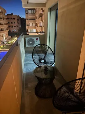 a balcony with two chairs and a window at Nice apartment in Marrakesh in Marrakech