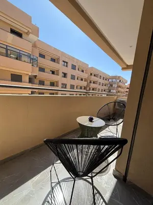 a balcony with a table and chairs on a building at Nice apartment in Marrakesh in Marrakech