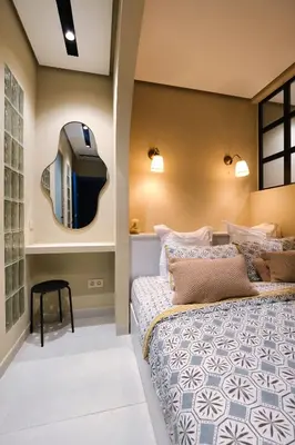 a bedroom with a bed with a tv on the wall at Luxury Studios with Balcony in Marrakech