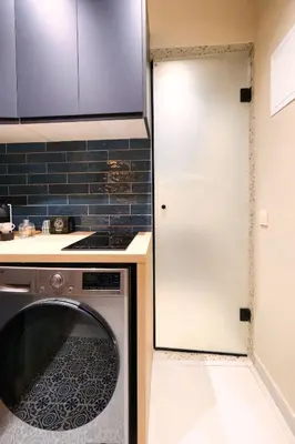 a kitchen with a washing machine and a white door at Luxury Studios with Balcony in Marrakech