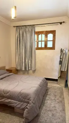 a bedroom with a large bed and a window at Cozy Garden Home in Marrakech in Marrakech