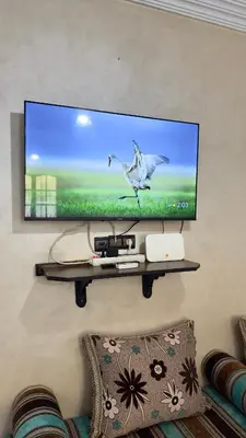 a flat screen tv hanging on a wall at Cozy Garden Home in Marrakech in Marrakech