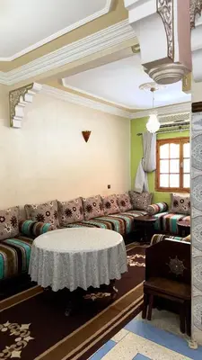 a living room with a couch and a table at Cozy Garden Home in Marrakech in Marrakech