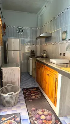 a kitchen with a refrigerator and a counter with food on the floor at Cozy Garden Home in Marrakech in Marrakech
