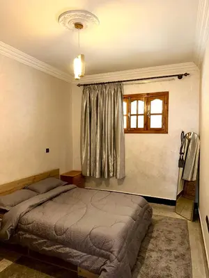 a bedroom with a bed and a window at Cozy Garden Home in Marrakech in Marrakech