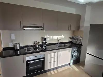 a small kitchen with a stove and a sink at Appartement Résidence Noria Marrakech in Marrakech