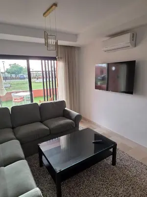 a living room with a couch and a coffee table at Appartement Résidence Noria Marrakech in Marrakech