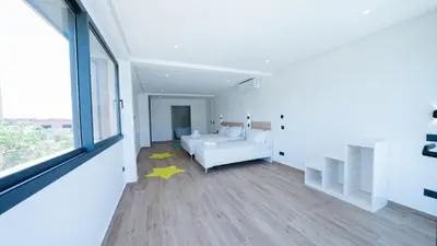 a bedroom with a white bed and a yellow star on the floor at Villa Adam in Oulad Akkou