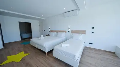 a bedroom with two beds and a star on the floor at Villa Adam in Oulad Akkou