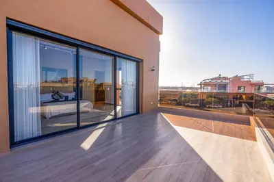 a balcony of a house with large glass windows at Villa iganis & Spa Marrakech in Marrakech
