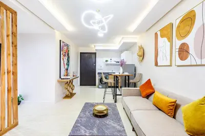 a living room with a couch and a table at Gueliz Comfort Corner Urban Apt in Marrakech