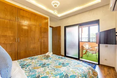 a bedroom with a bed and a large window at Gueliz Comfort Corner Urban Apt in Marrakech