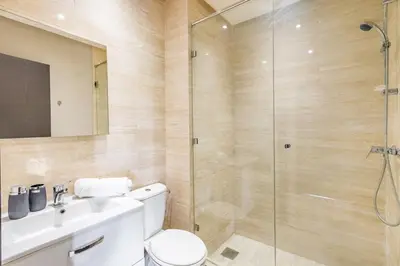 a bathroom with a shower and a toilet and a sink at Luxurious 3BR by to the pool in Marrakech