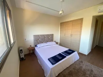 a bedroom with a large white bed and a window at Luxury apartment with 2 pools in Marrakech