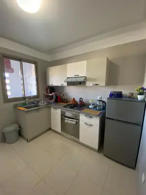 a kitchen with a sink and a stove top oven at Luxury apartment with 2 pools in Marrakech