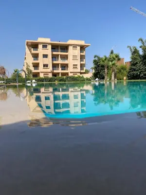a reflection of a building in a pool of water at Luxury apartment with 2 pools in Marrakech