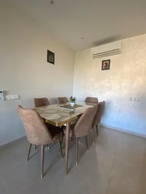 a dining room with a wooden table and chairs at Luxury apartment with 2 pools in Marrakech
