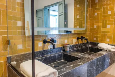a bathroom with a sink and a mirror at Riad Dar Ben Slimane in Marrakech
