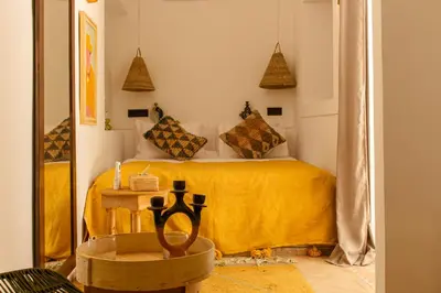 a bedroom with a bed with a yellow blanket at Riad Dar Ben Slimane in Marrakech