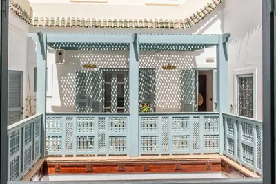 a house with a blue and white balcony at Riad Dar Ben Slimane in Marrakech