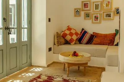 a living room with a couch and a table at Riad Dar Ben Slimane in Marrakech
