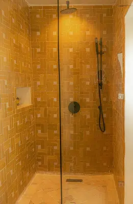a shower with a glass door in a bathroom at Riad Dar Ben Slimane in Marrakech