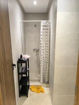 a bathroom with a shower with a shower curtain at Nour Prestige in Marrakech