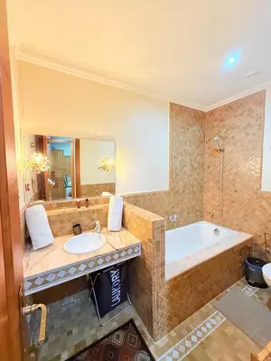 a bathroom with a tub and a sink at 2 - Bed Apartment with Garden & shared Pool - Moroccan - Modern Style in Marrakech