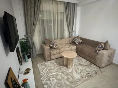 a living room with a couch and a table at Modern One Bedroom Apartment in Central Gueliz Marrakech in Marrakech