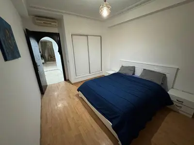 a bedroom with a blue bed and a mirror at Modern One Bedroom Apartment in Central Gueliz Marrakech in Marrakech