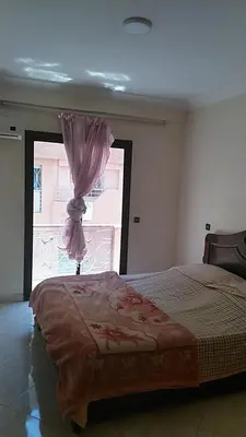 a bedroom with a large bed with a window at Marrakech Allal El Fassi in Marrakech