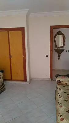 a room with a door and a couch and a mirror at Marrakech Allal El Fassi in Marrakech