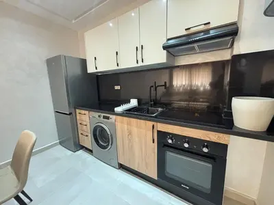 a kitchen with a stove and a washer and dryer at Majorelle Retreat - Luxury Studio in Marrakech