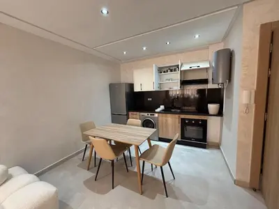 a kitchen and dining room with a table and chairs at Majorelle Retreat - Luxury Studio in Marrakech