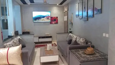 a living room with a couch and a tv at Cozy Flat near Gueliz in Center in Marrakech