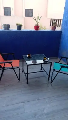 two chairs and a coffee table on a patio at Cozy Flat near Gueliz in Center in Marrakech