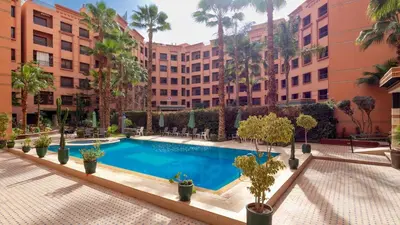 a courtyard with a swimming pool in a building at Apartment for rent Wintering in Marrakech
