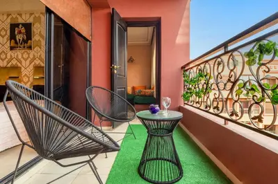 a balcony with two chairs and a table on a balcony at Apartment for rent Wintering in Marrakech