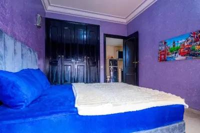 a bedroom with a bed in a purple room at Apartment for rent Wintering in Marrakech