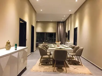 a large dining room with a table and chairs at Villa Djamila Marrakech in Marrakech
