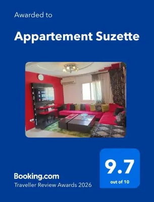 a living room with red walls and a red couch at Appartement Suzette in Marrakech