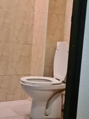 a bathroom with a white toilet in a room at Hotel Apart LRB in Marrakech